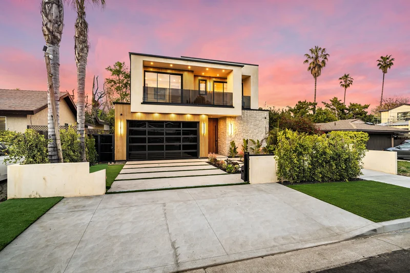 Modern home with clean landscape installation at sunset.