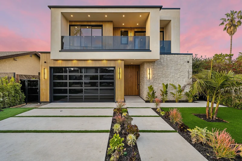 Modern home exterior featuring professional luxury landscape installation